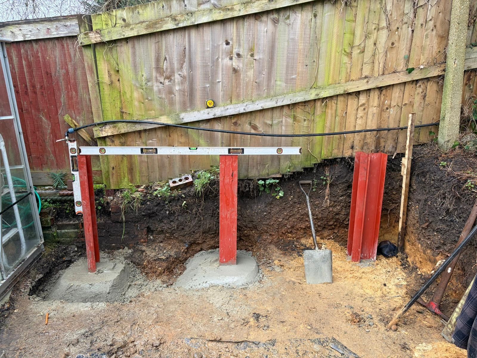 During the build, retaining posts set in concrete footings