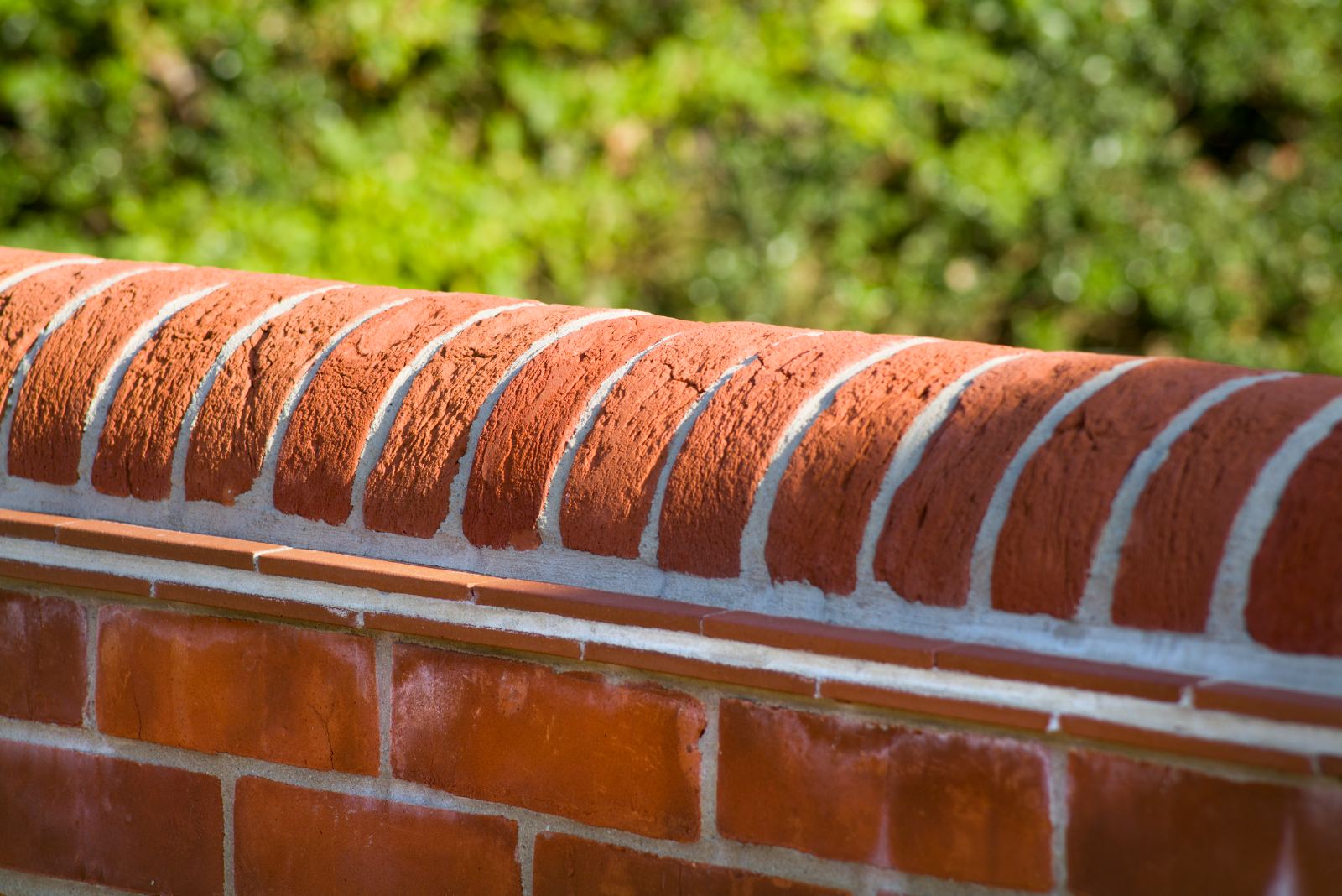 Detail of a brick wall's rounded coping course